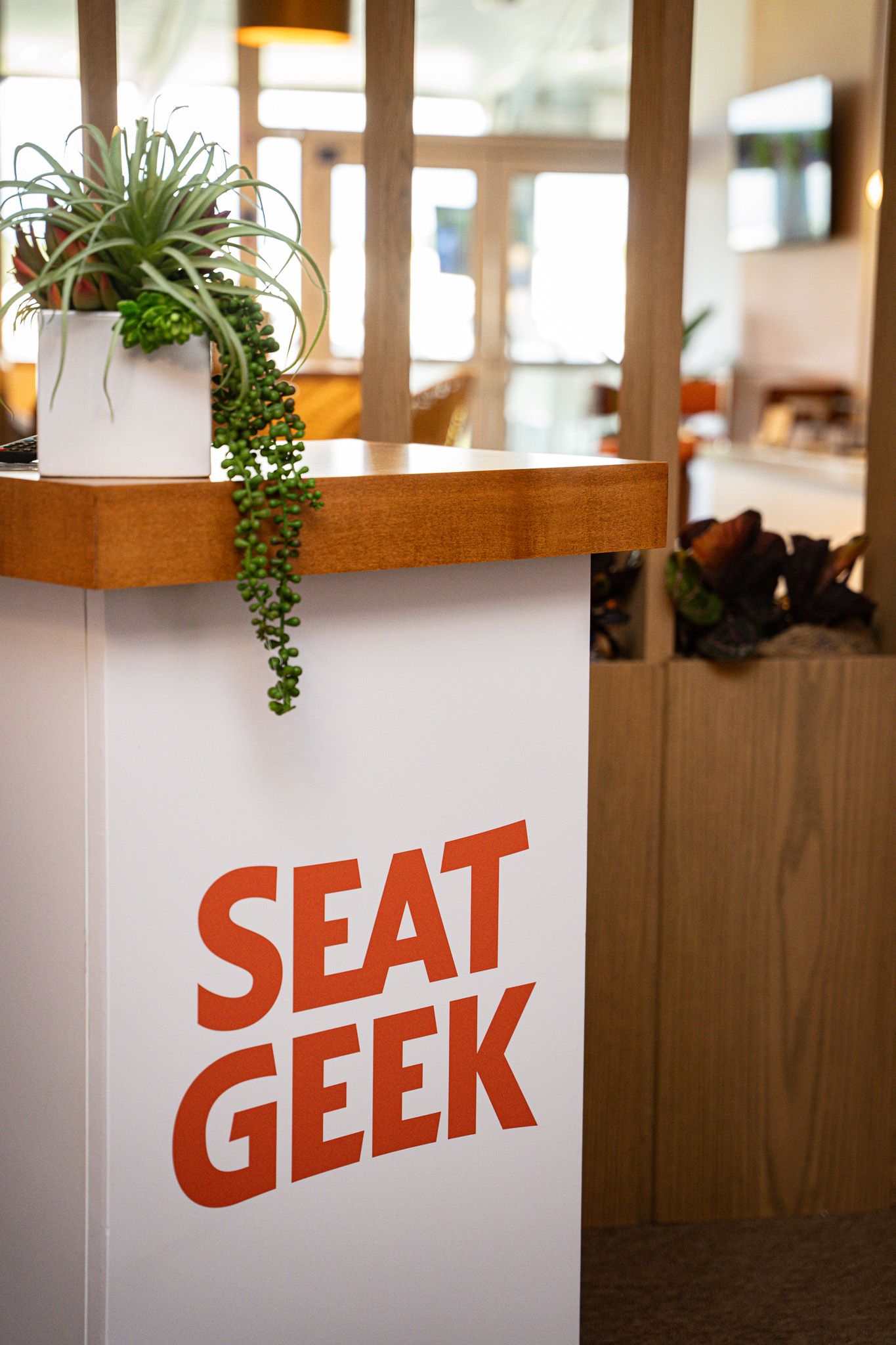 Corporate event photography of a company suite at the U.S. Open Golf Championship in the Hamptons, NY featuring a  branded podium
