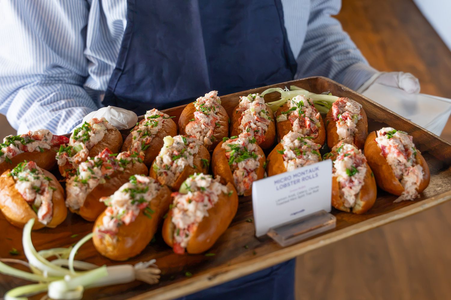 Event photography of server holding a tray of lobster rolls inside the 1895 club at the U.S. Open Golf Championship in the Hamptons, NY