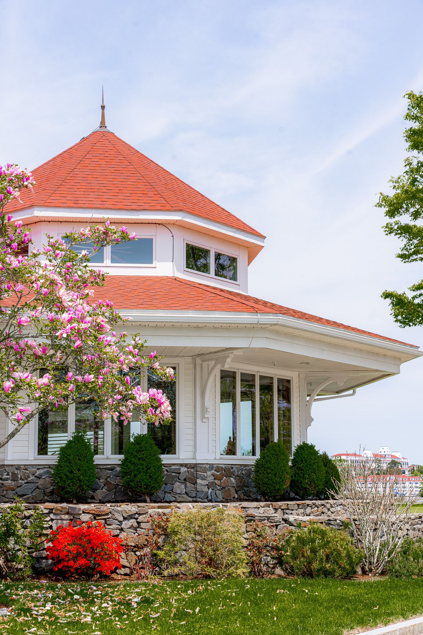 Wedding photography of Wentworth by the Sea Country Club featuring a classic coastal white shingled building with a red roof on a Spring day
