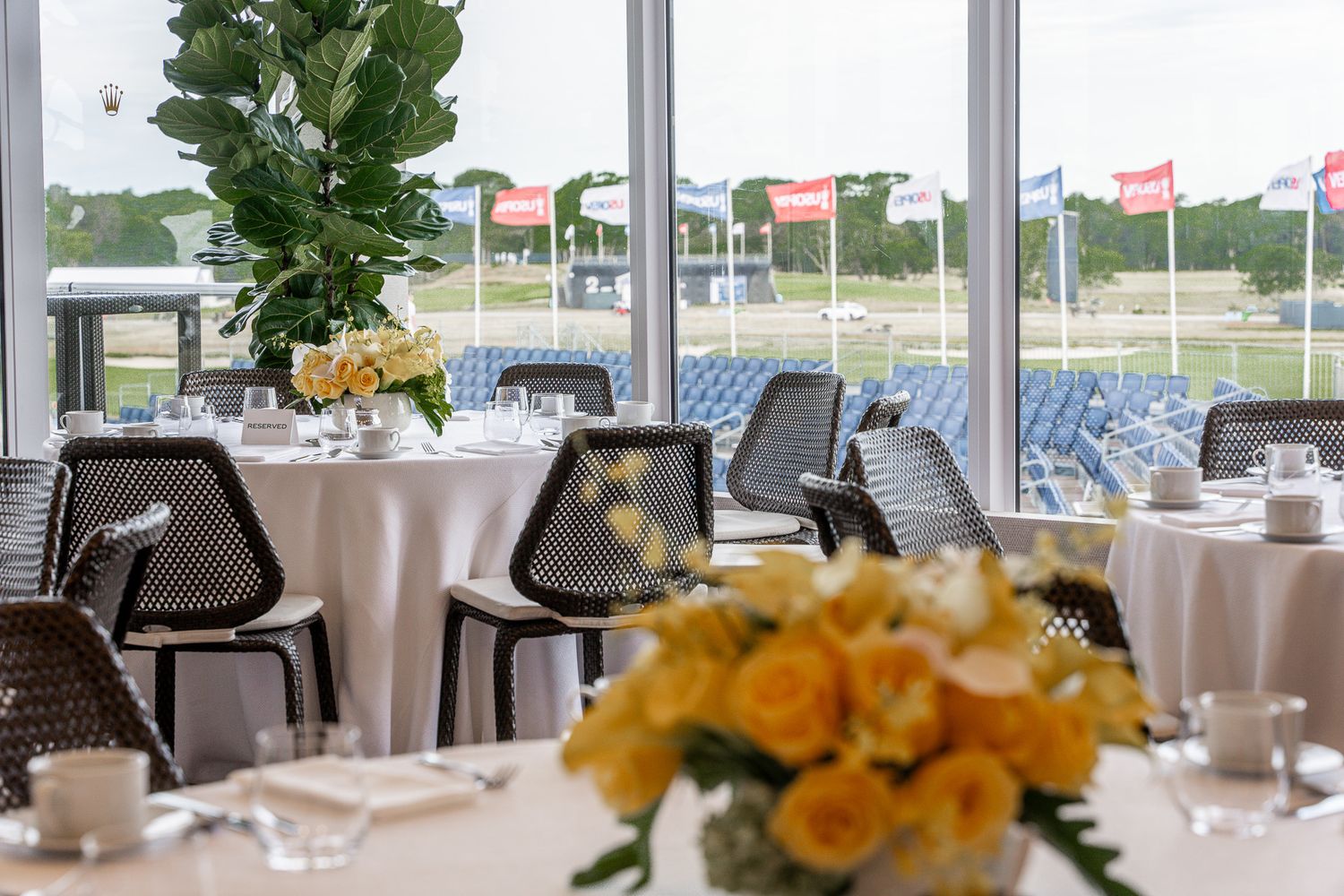 Corporate event photography of a company suite at the U.S. Open Golf Championship in the Hamptons, NY featuring luxe dining tables