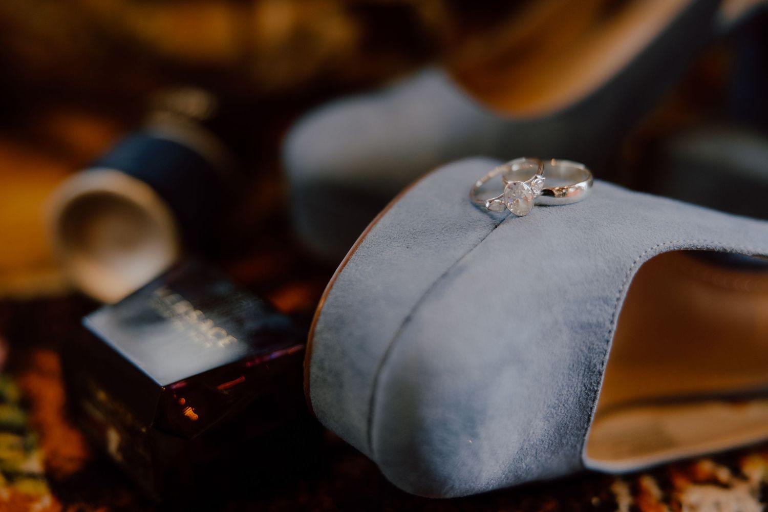 Bride and groom detail photos from their elopement day capturing every detail and small moment with shoes, rings, and perfume/cologne.