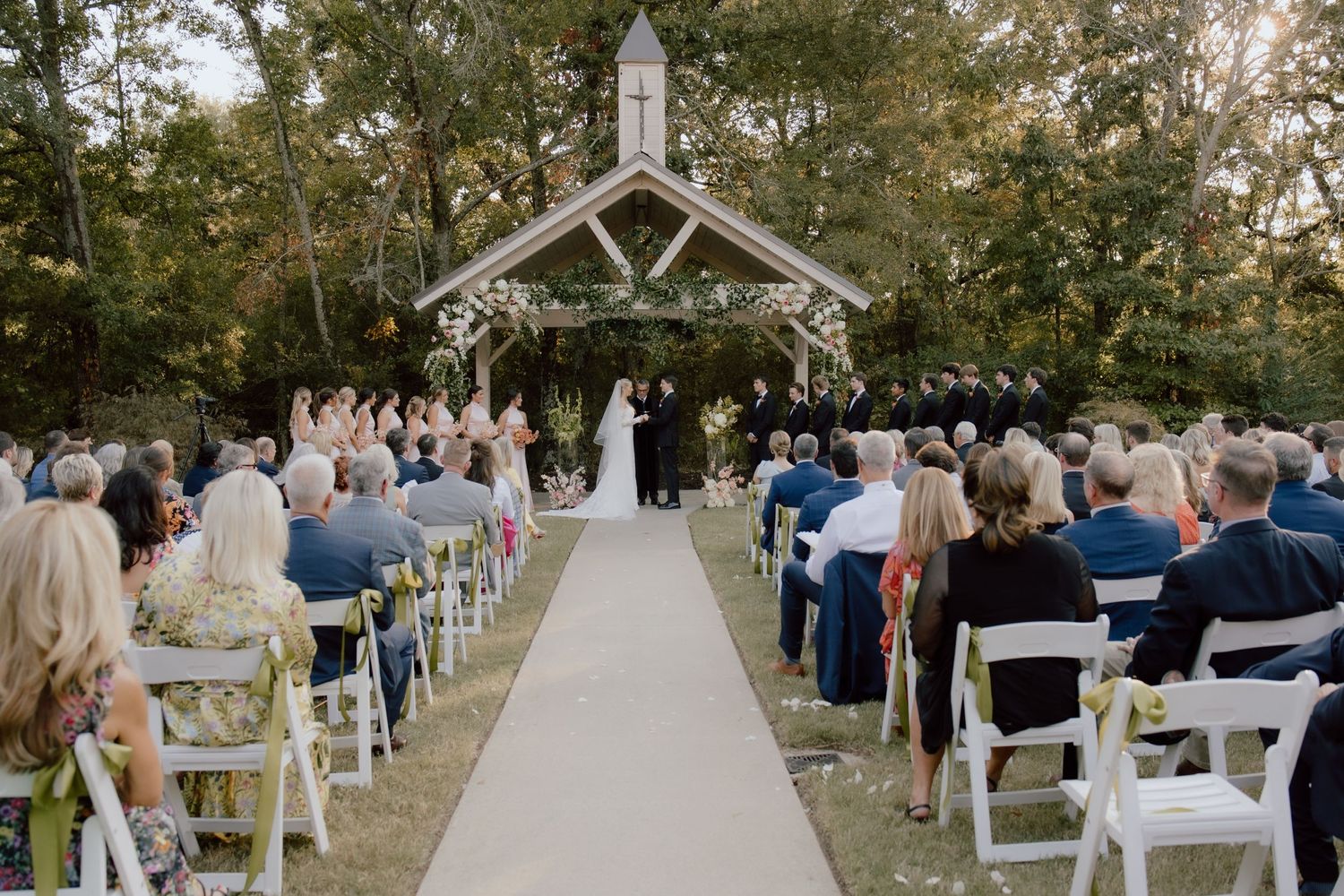 Outdoor wedding ceremony location in Arkansas with chapel at The Loft at Stone Oak in Greenwood, Arkansas featuring documentary style photo.