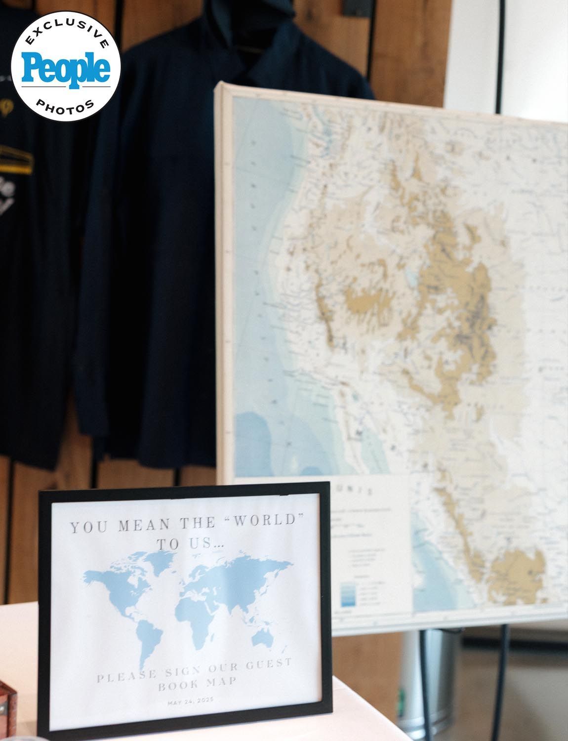 People Magazine exclusive photo that is showcasing the couples unique world map guest book on their wedding day.