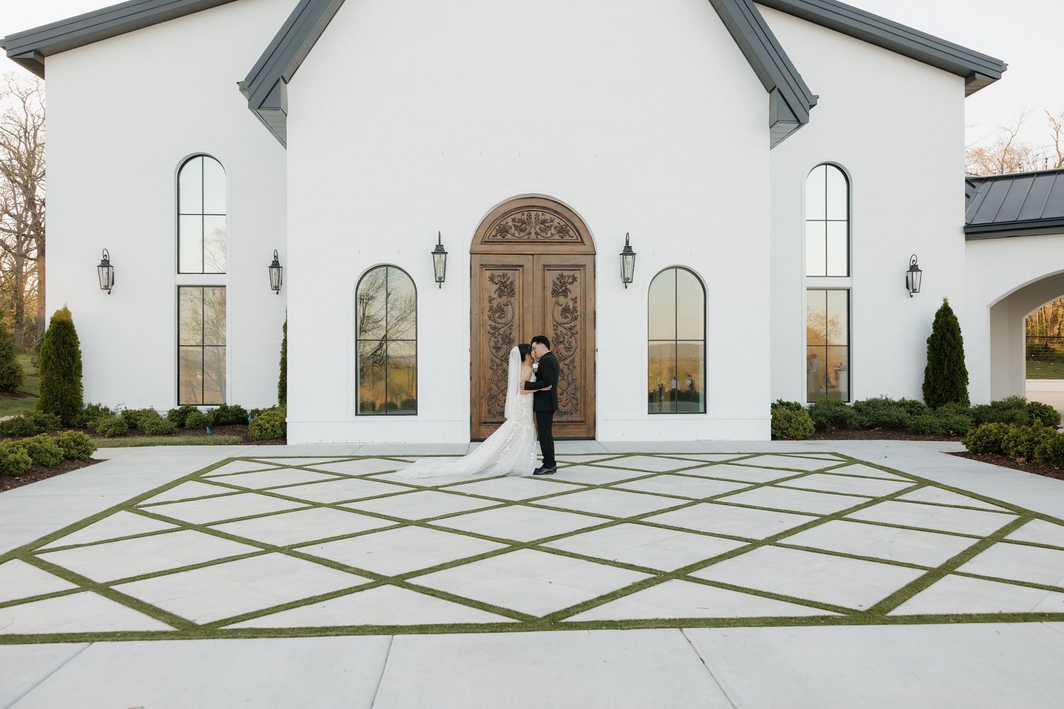 Bride and groom sharing a moment together outside of The Grand at Willow Springs chapel during their wedding.