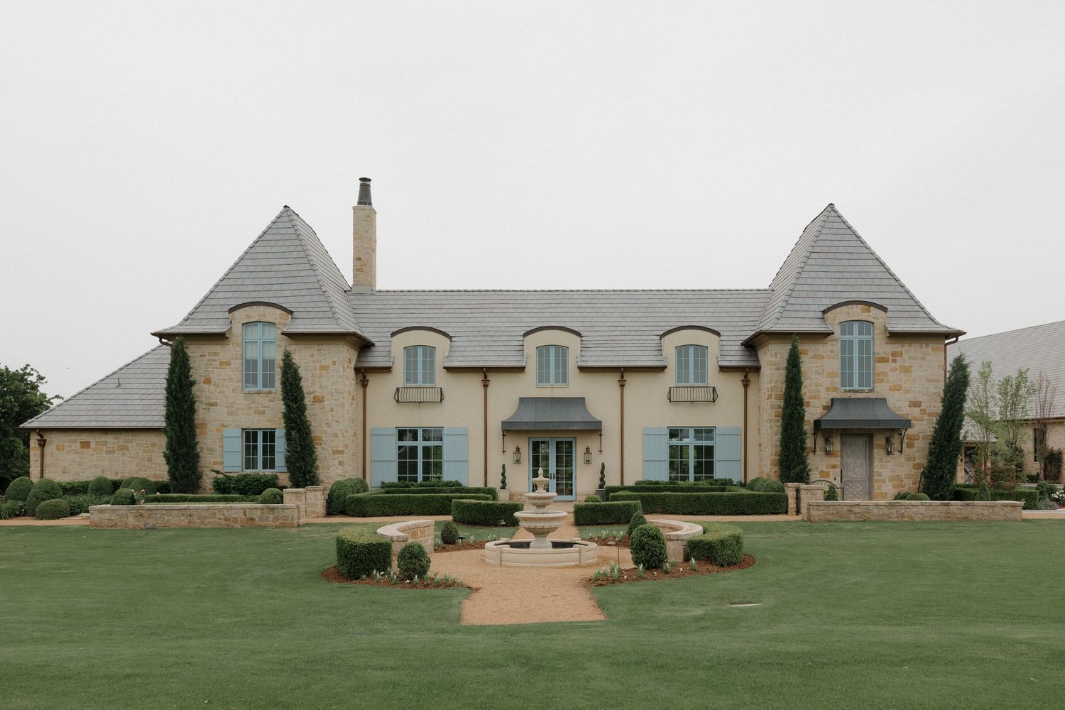 Exterior of The Bower in Edmond Oklahoma with European estate-style architecture.