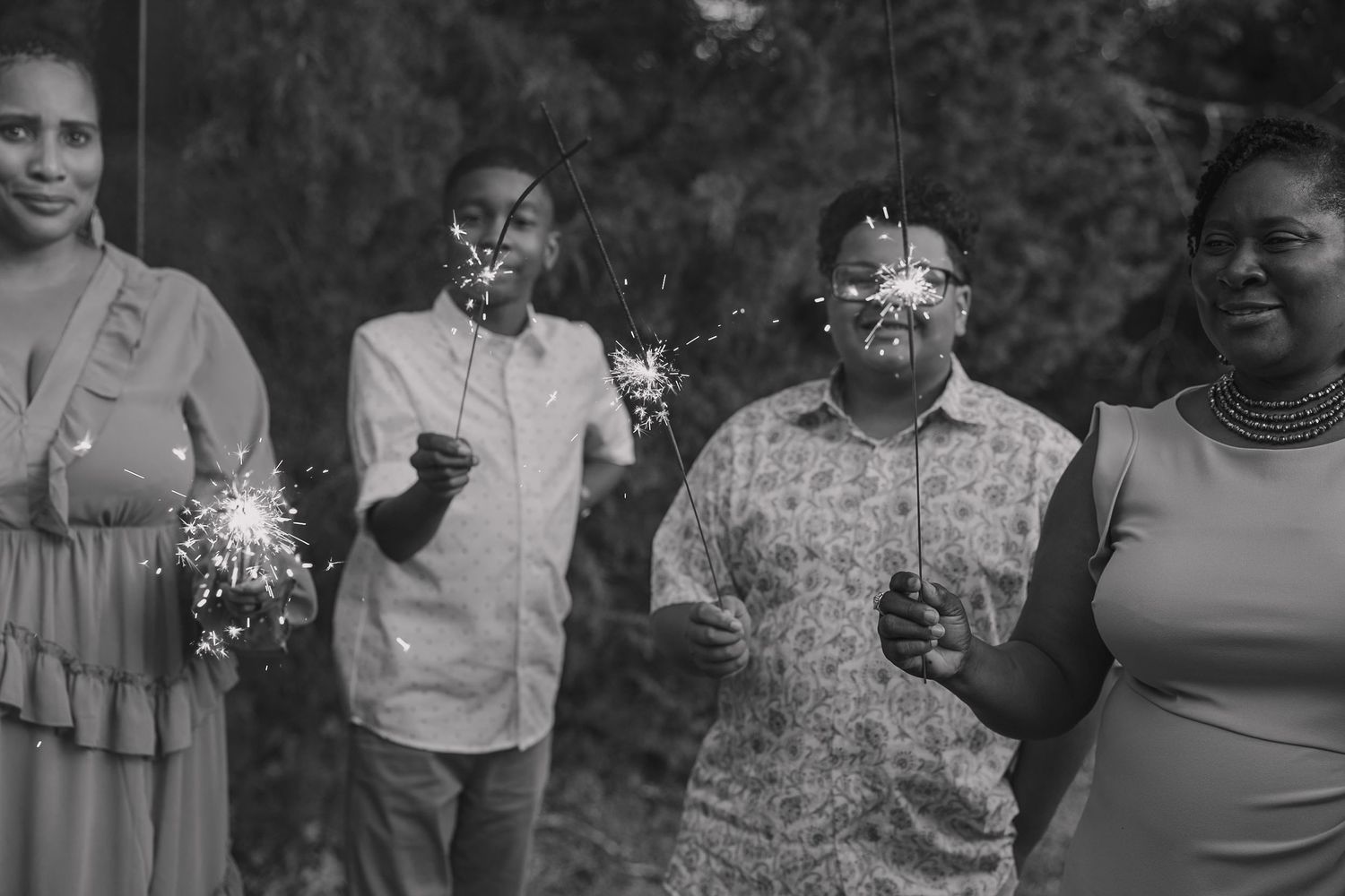 Wedding guests with sparklers awaiting the bride and groom to exit the reception.