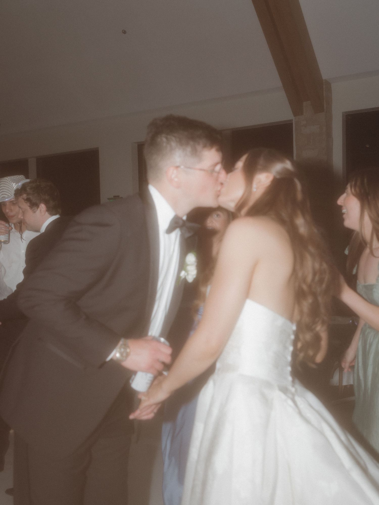 Bride and groom kissing on the dance floor in this film photography photo.