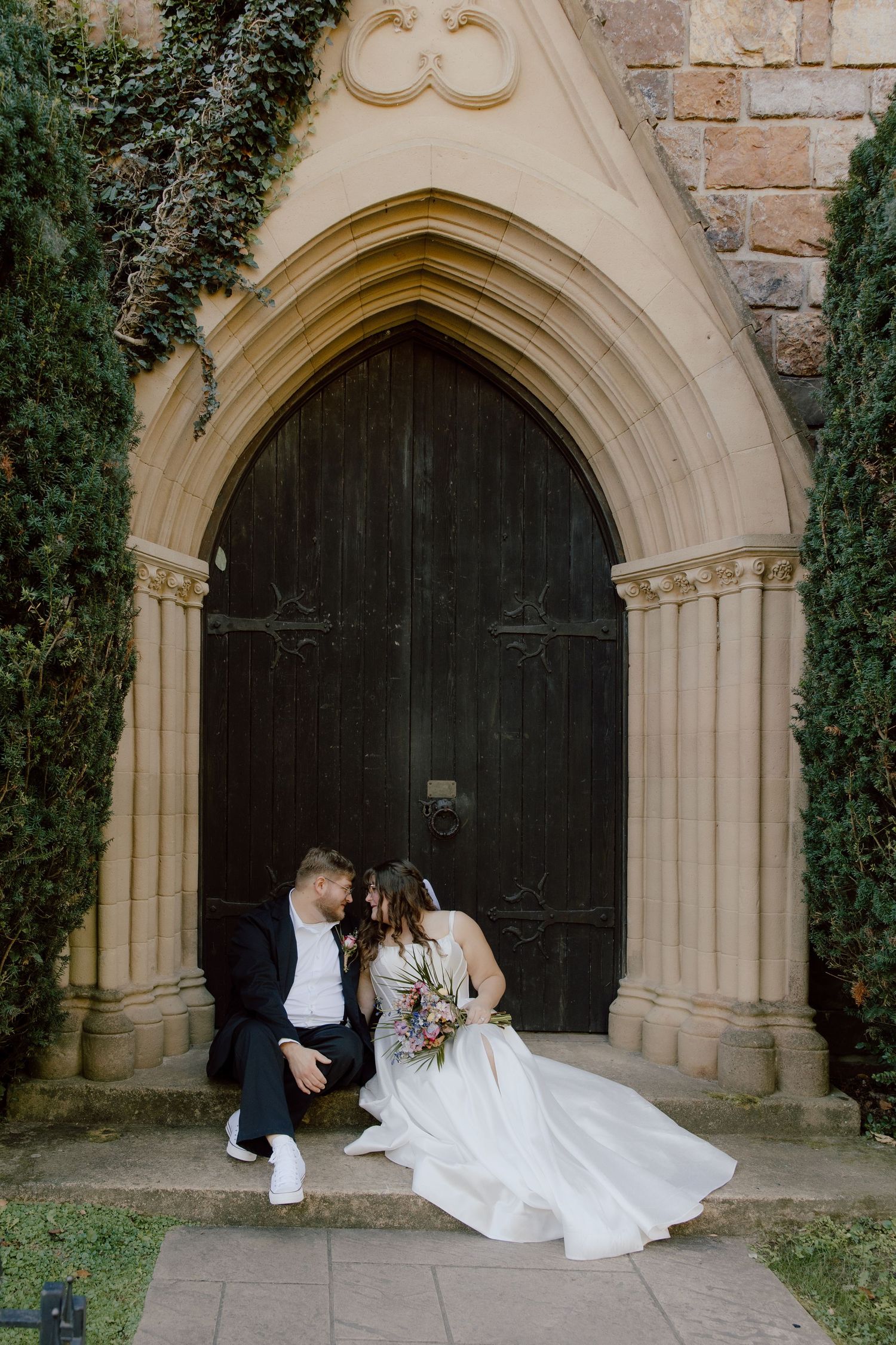 Bride and groom posed outside of the castle like doors of St. Catherine's Bell Gable small affordable wedding venue for elopements.