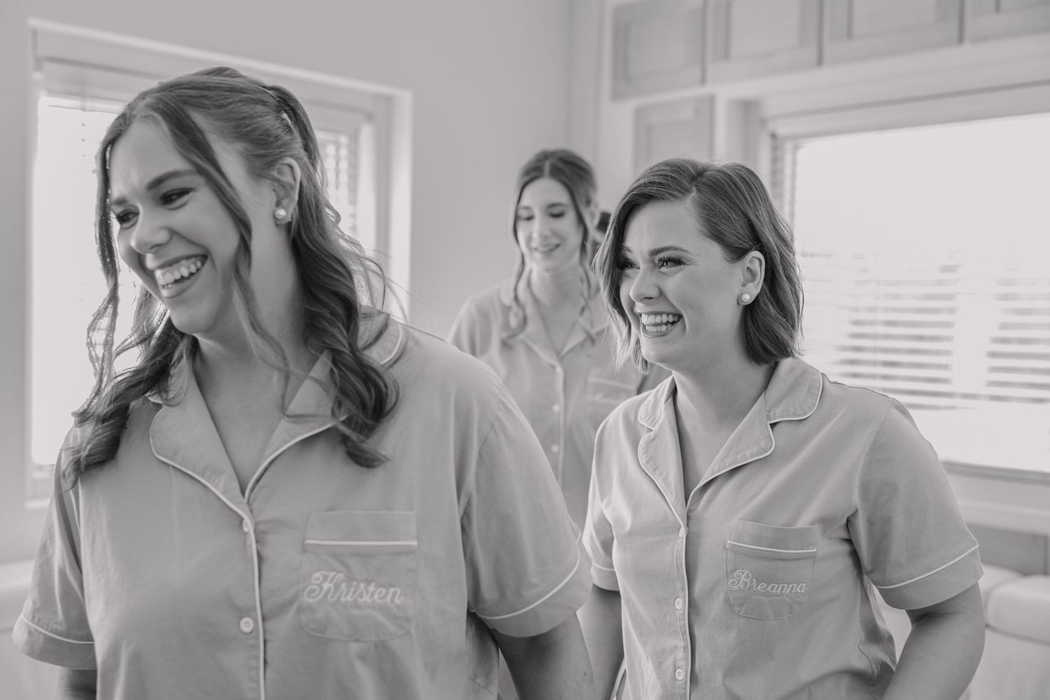 Candid moment of bridesmaids smiling during the getting ready portion of the wedding day.