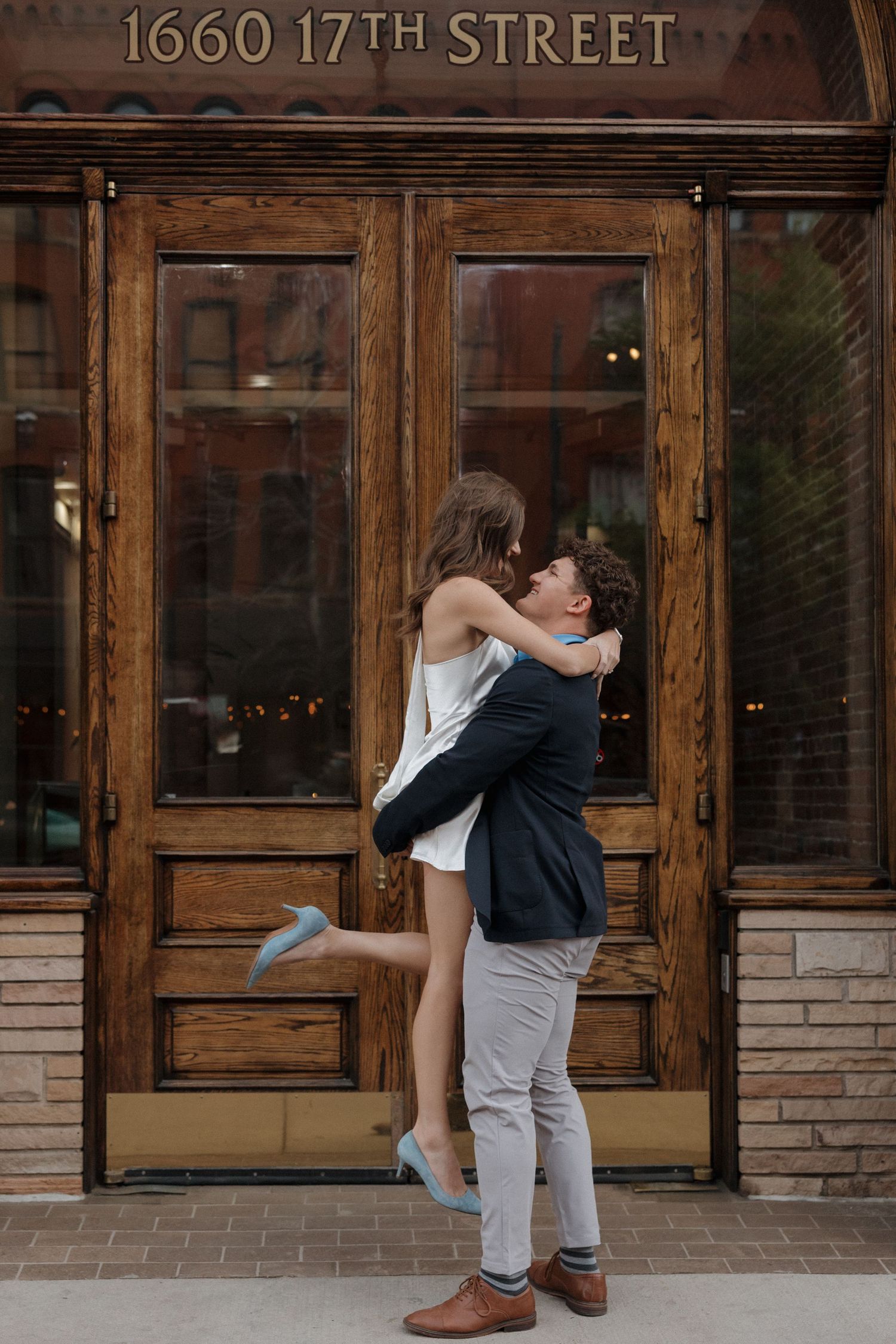 Editorial engagement photography outside Union Station with relaxed posing and genuine interaction, captured by Denver engagement photograph