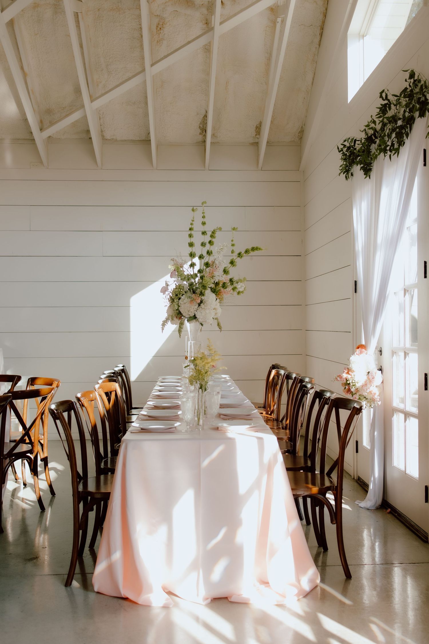Bright, airy, classic, luxury wedding photography of reception table with pink table cloths and true to life coloring by Malachi Westbrook.