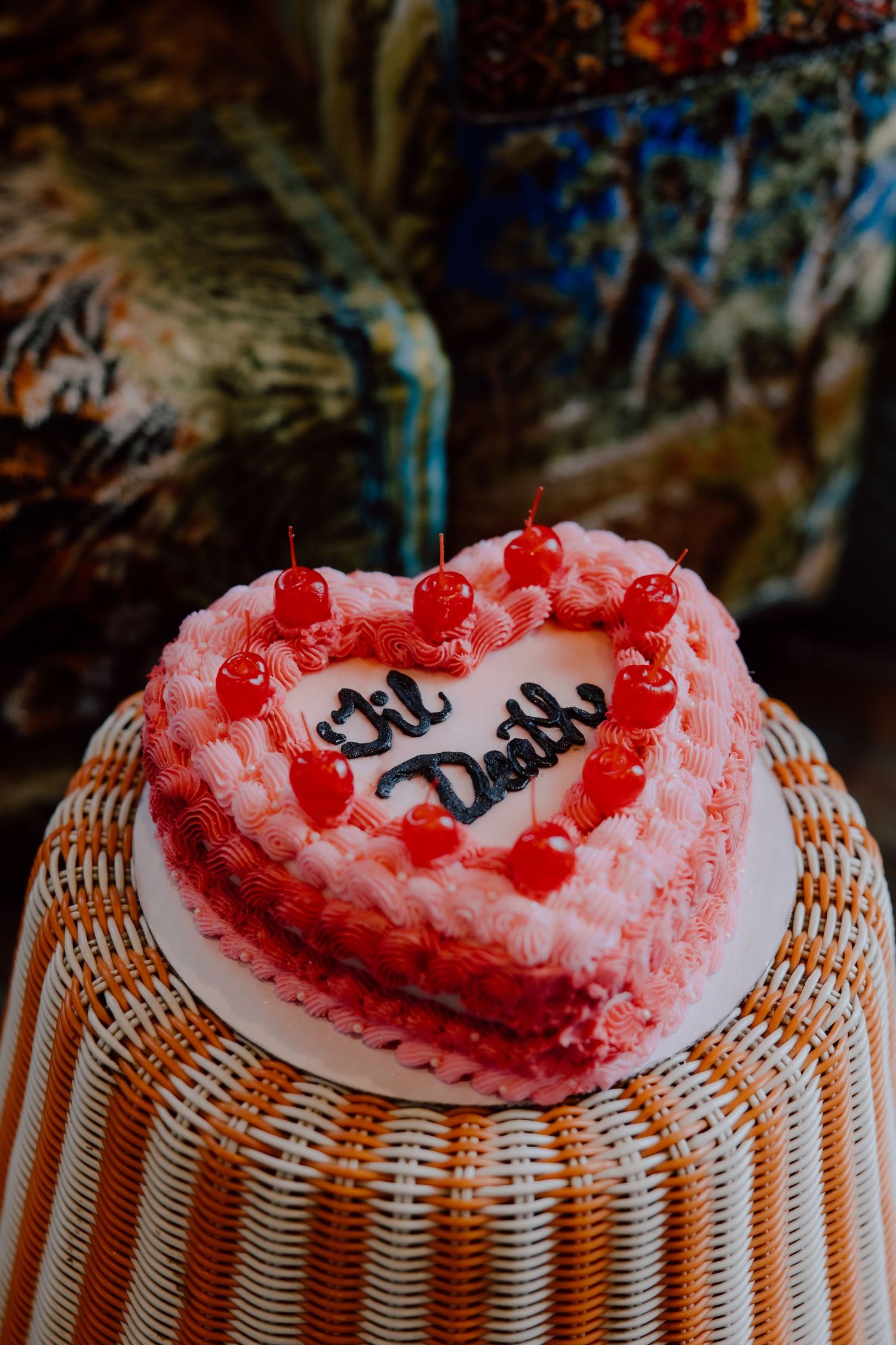 Pink and red heart shaped wedding cake with the phrase 