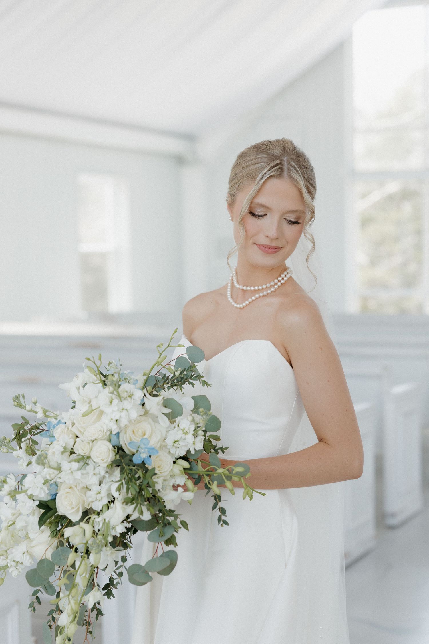 Bride holding bouquet in natural light at Cold Springs Events wedding venue