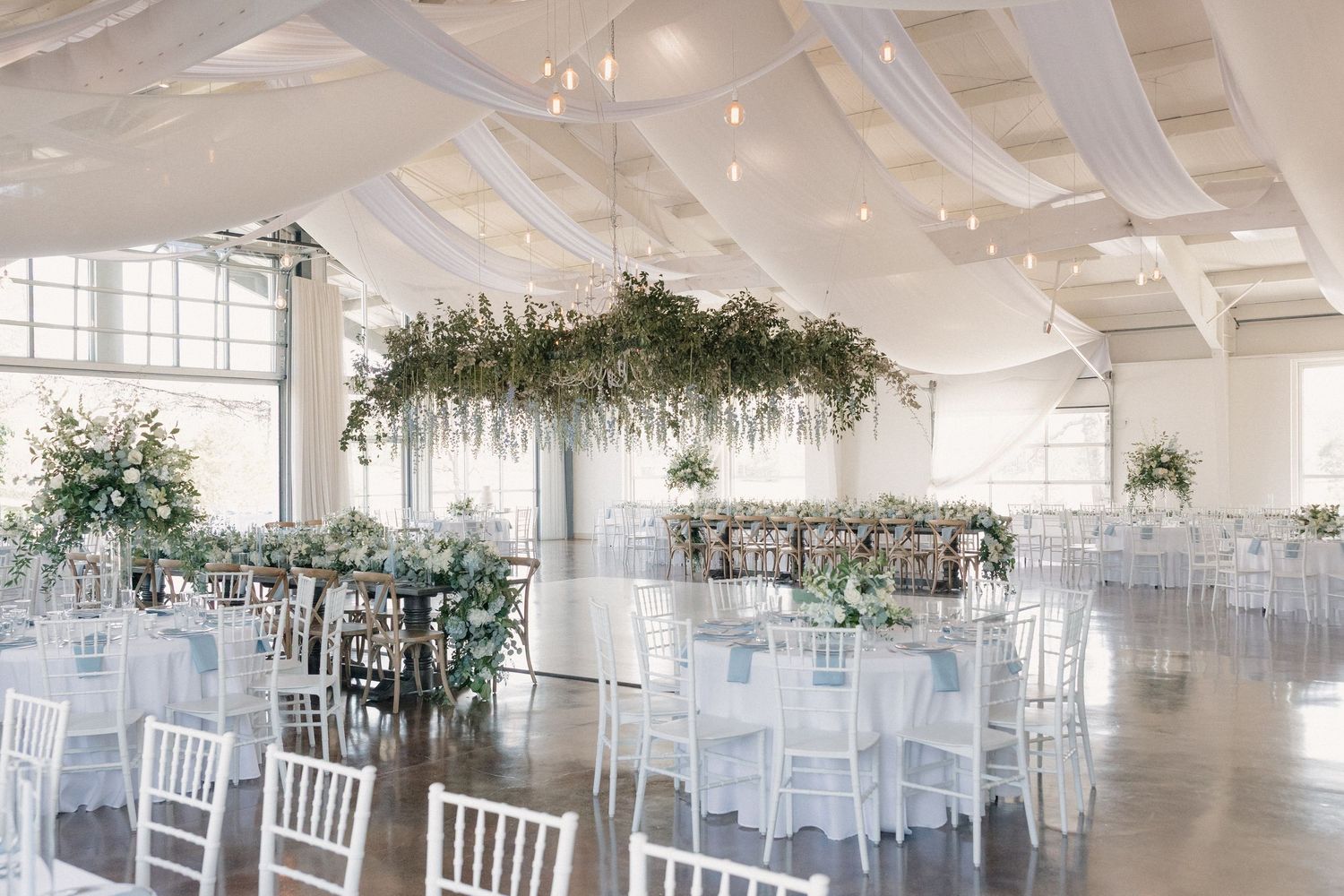 Wide shot of modern reception space set for dinner at Cold Springs Events venue