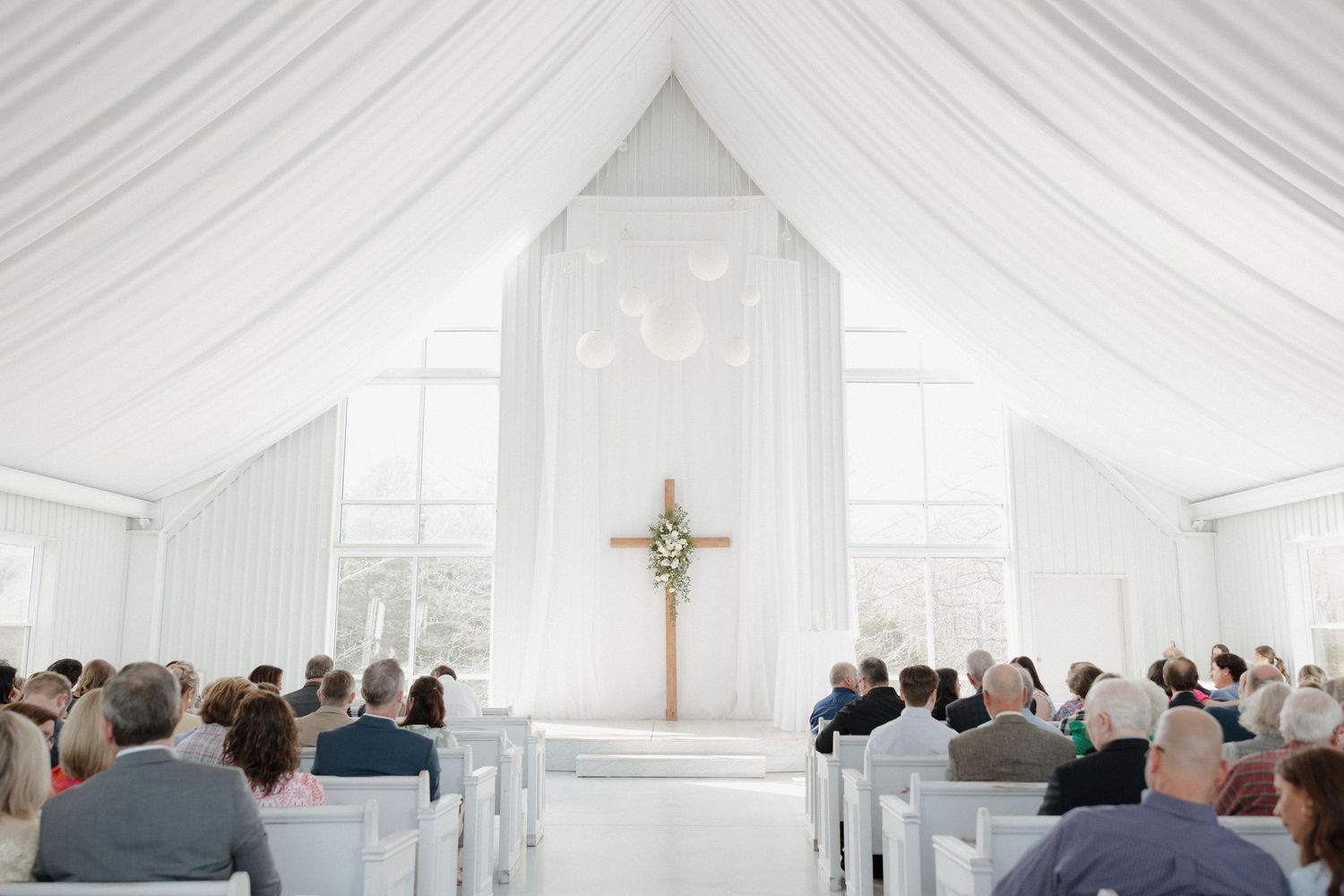 Wedding ceremony inside glass chapel at Cold Springs Events near Little Rock
