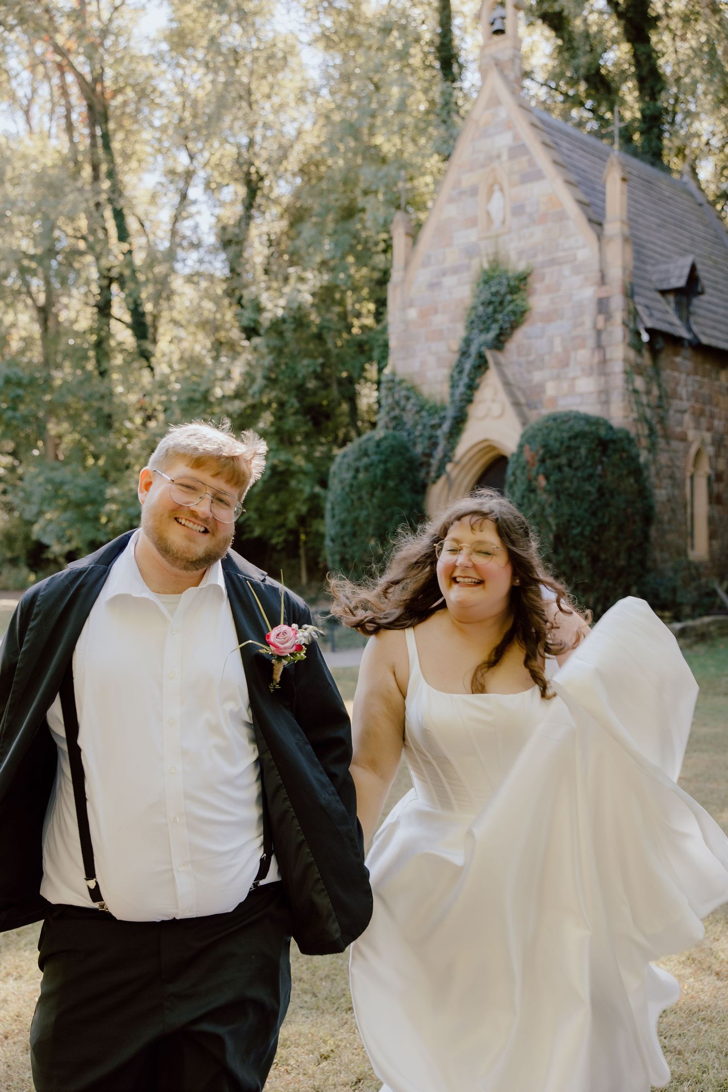 Joyful, candid, fun, in the moment photograph of bride and groom running away from their wedding venue in Arkansas.