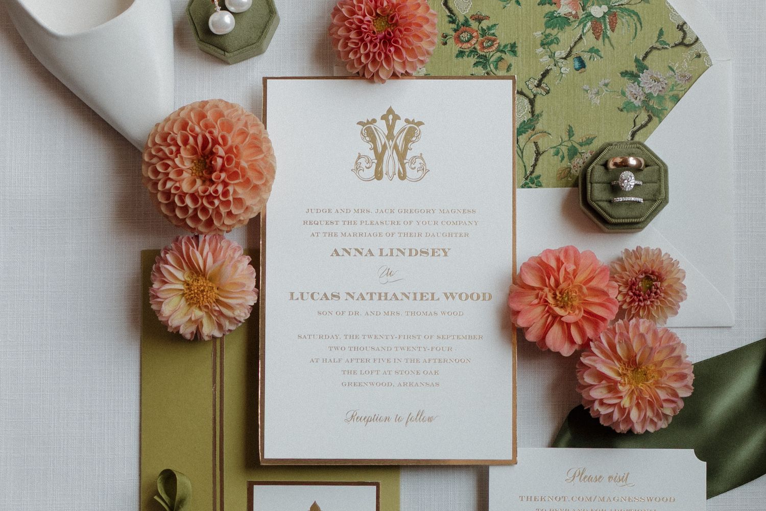 Detail photo showcasing a wedding invitation, beautiful florals, and pink, orange, and green tones from wedding day.