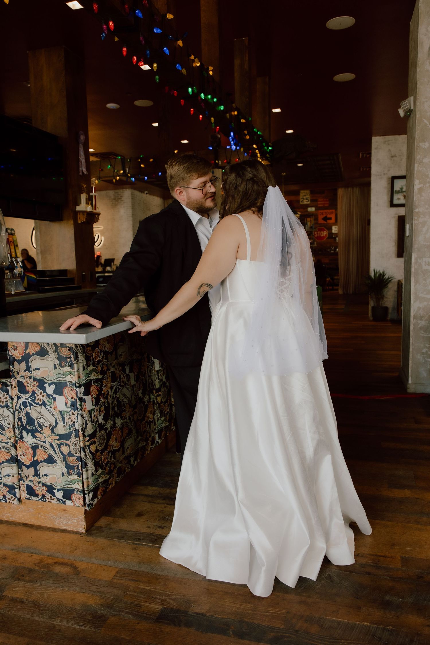 Bride and groom portrait in front of the bar at the graduate hotel in a flash photography style.