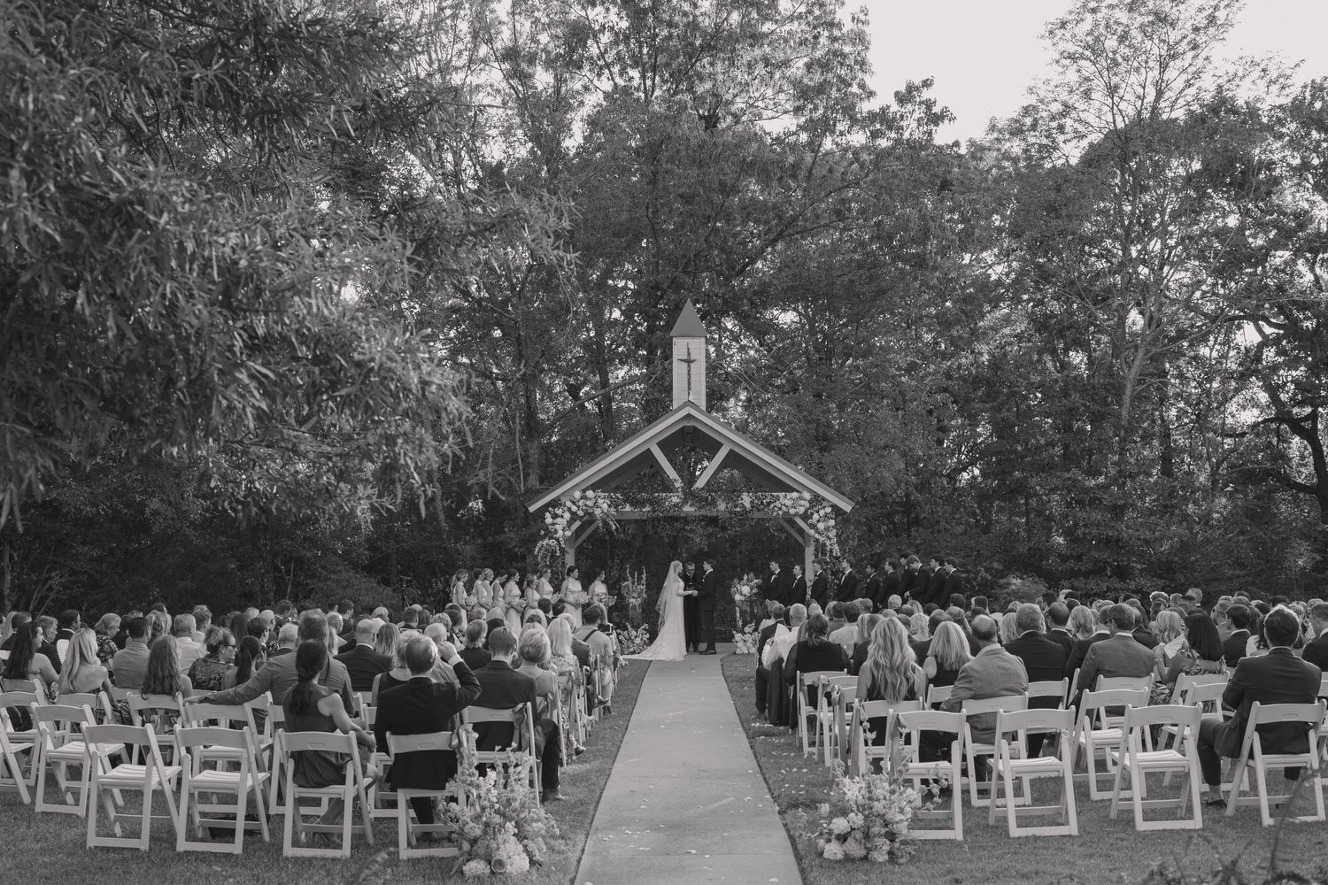 Photograph of outdoor wedding ceremony in black in white for Summer wedding at The Loft at Stone Oak in timeless, documentary style.
