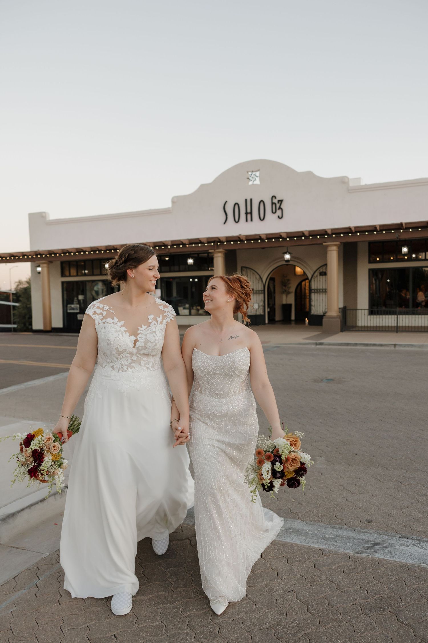 Bride and bride walking out from their wedding at SOHO 63 wedding venue in Downtown Chandler Arizona taken by photographer Malachi Westbrook