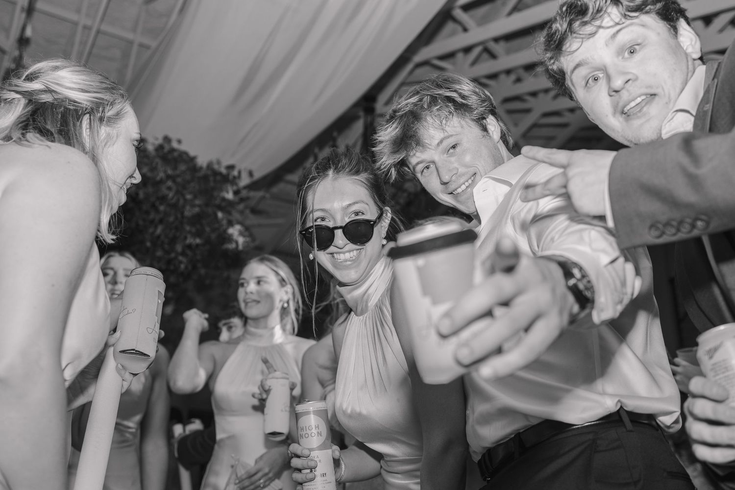 Wedding guests dancing during a candid reception moment.