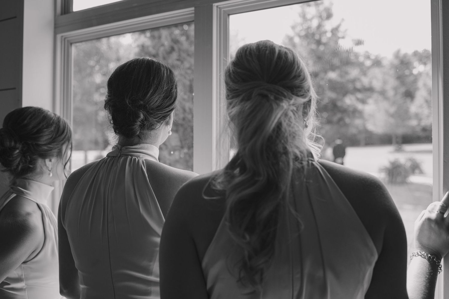Documentary style wedding photography at Arkansas Wedding venue, The Loft at Stone Oak, black and white photo of bridesmaids looking out.