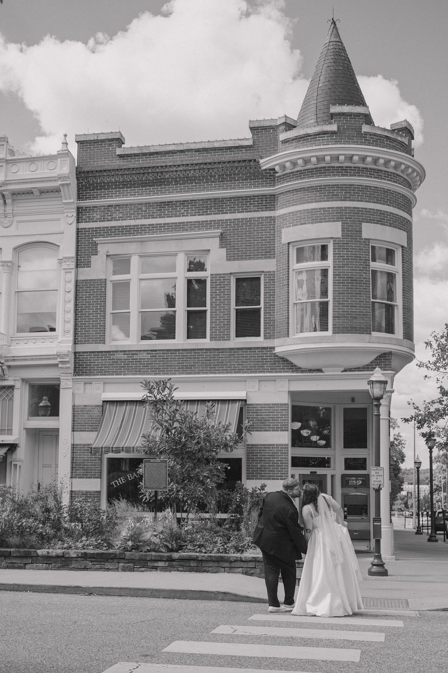 Bride and groom caught in a candid moment documenting their elopement day celebration at the downtown square area of NWA.