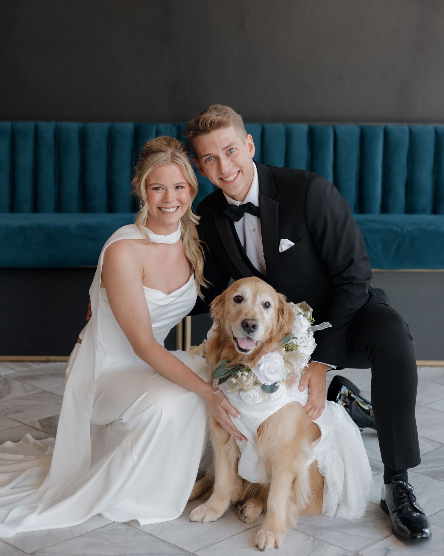 Couple posing with their dog on their wedding day taken at The Brick Ballroom in Siloam Springs Arkansas.