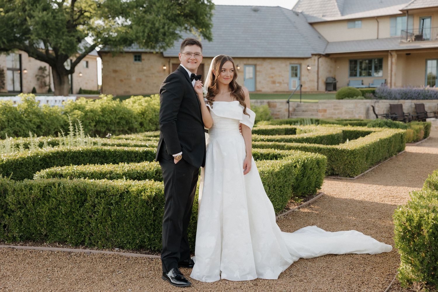 Bride and groom posed together in the gardens of The Bower.