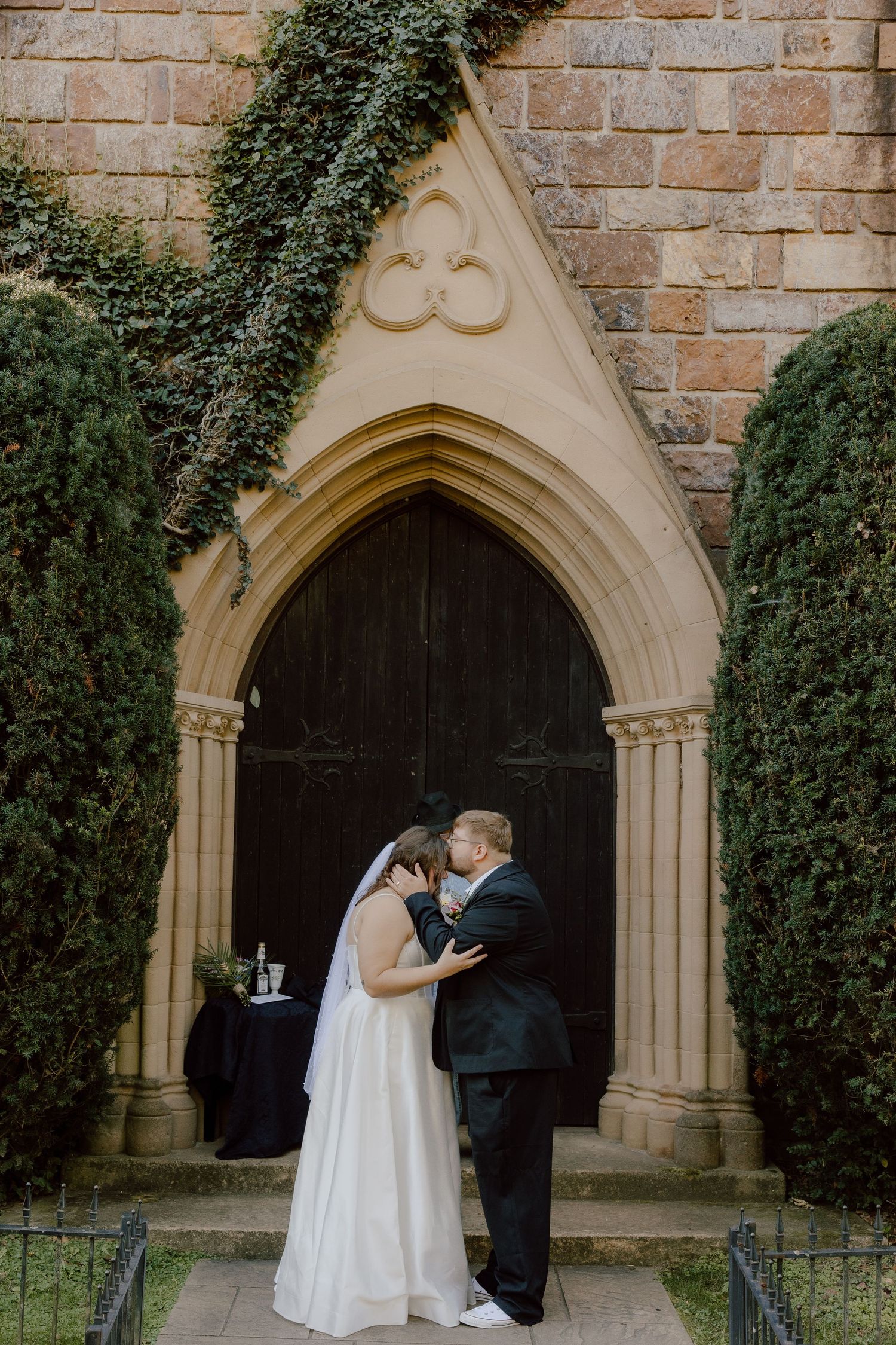 Arkansas wedding day featuring the couple during their first kiss after eloping at St Catherines Bell Gable.