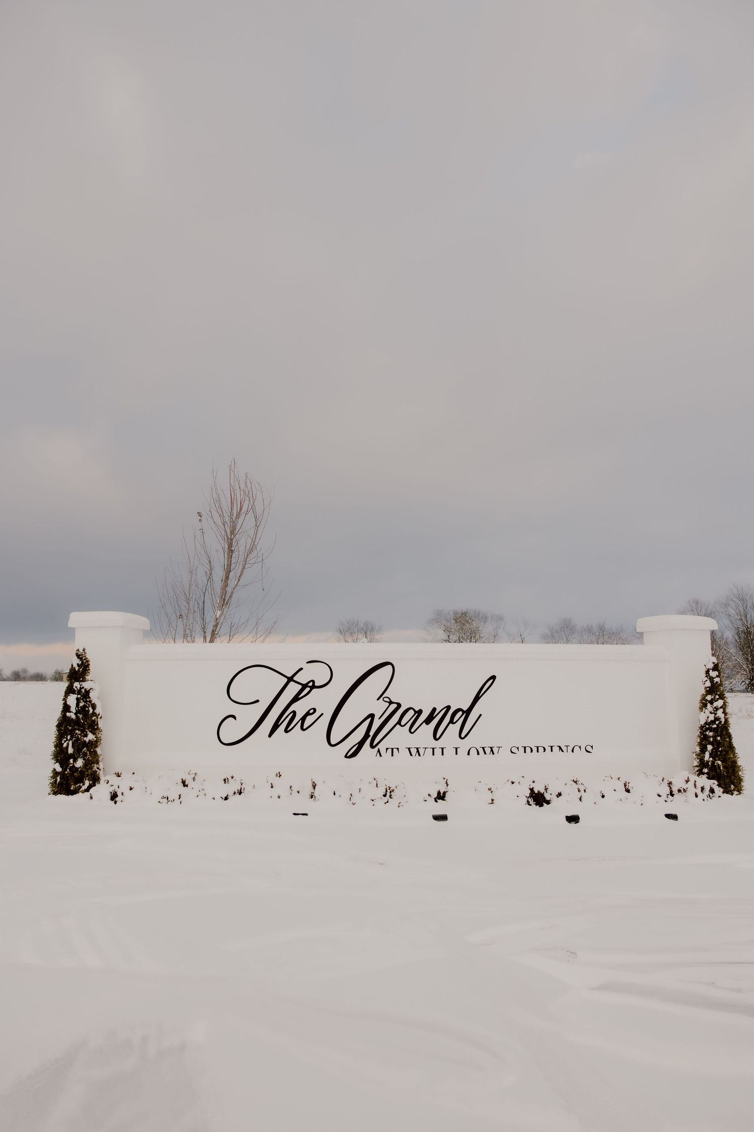 The Grand at Willow Springs wedding venue sign in Northwest Arkansas on a snowy winter day.
