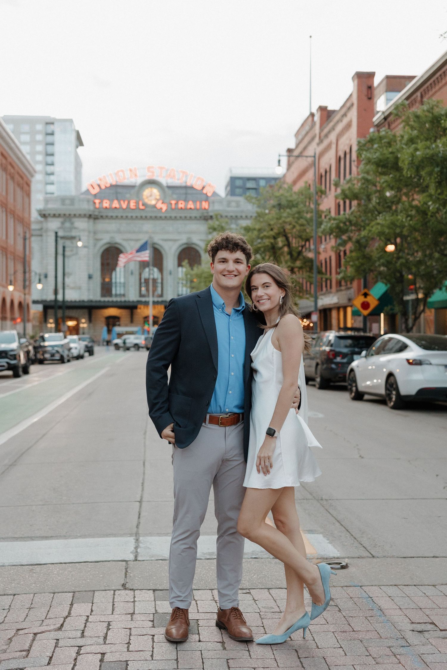 Editorial engagement photography outside Union Station with relaxed posing and genuine interaction, captured by Denver engagement photograph