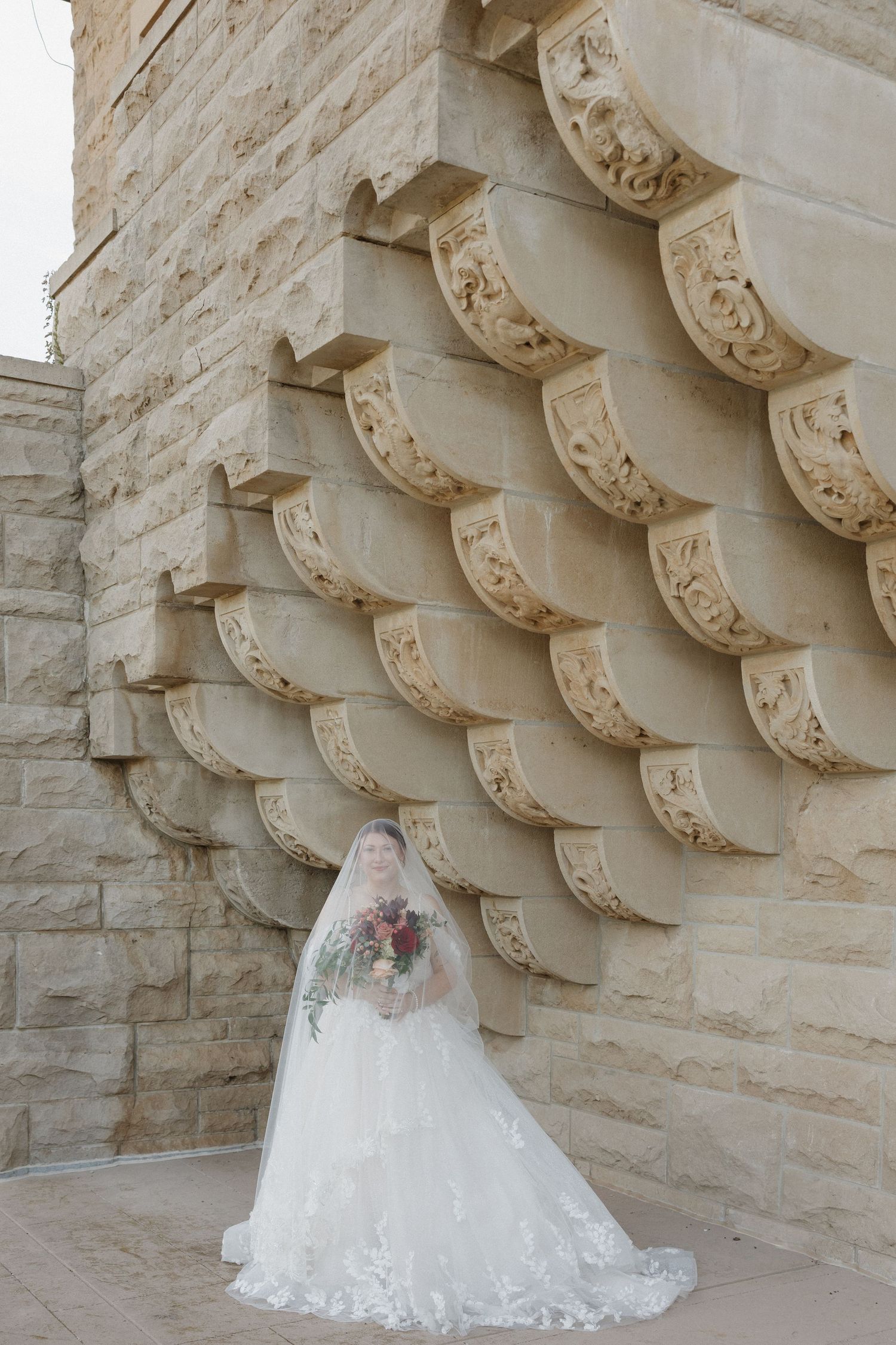 Bridal portrait of bride on wedding day with the stunning architecture of marland mansion.