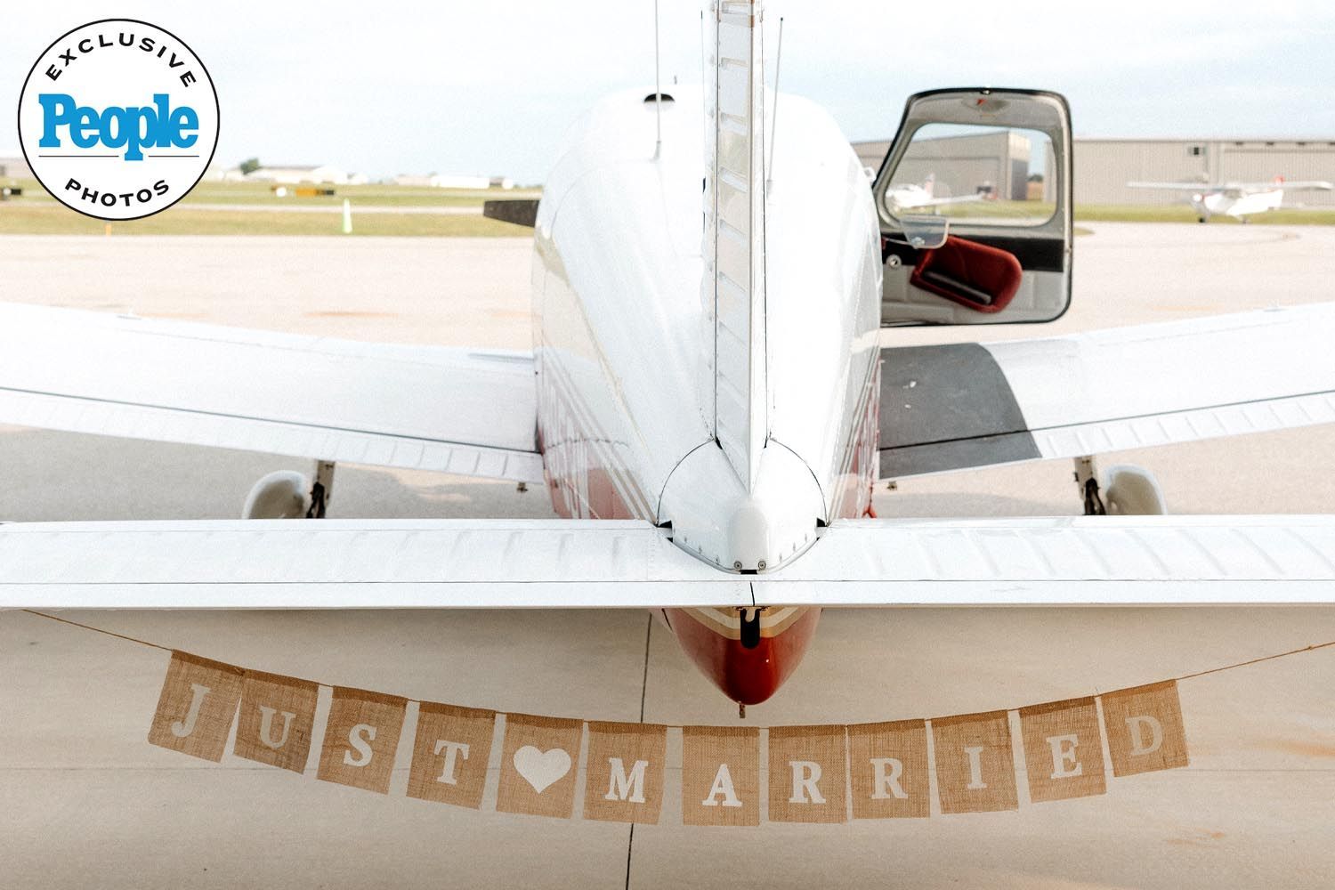 Just married sign hanging on the back of airplane in a People Magazine exclusive photo taken by Malachi Westbrook Photography.