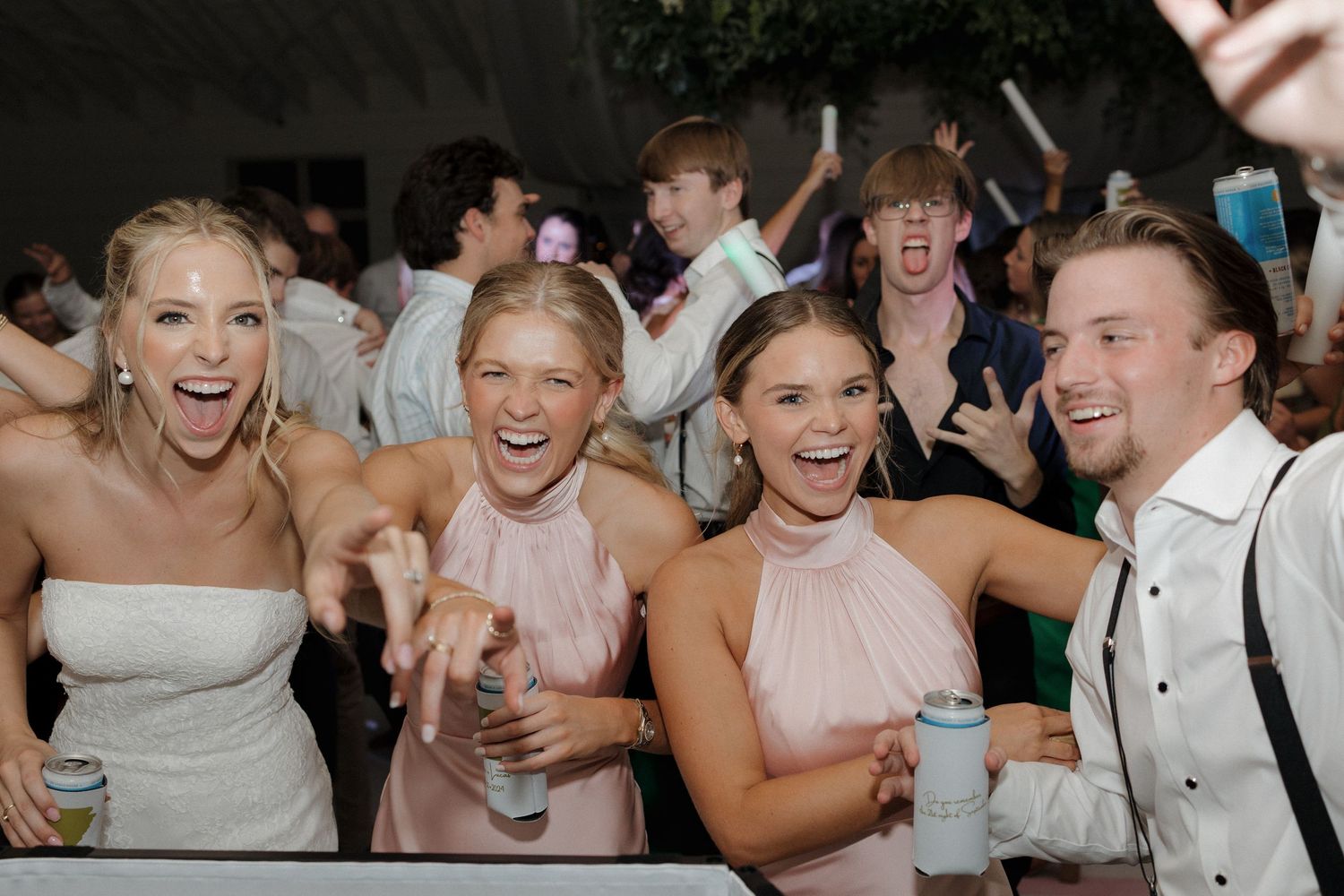 Party moment during the wedding reception where guests and bride are celebrating and very happy.