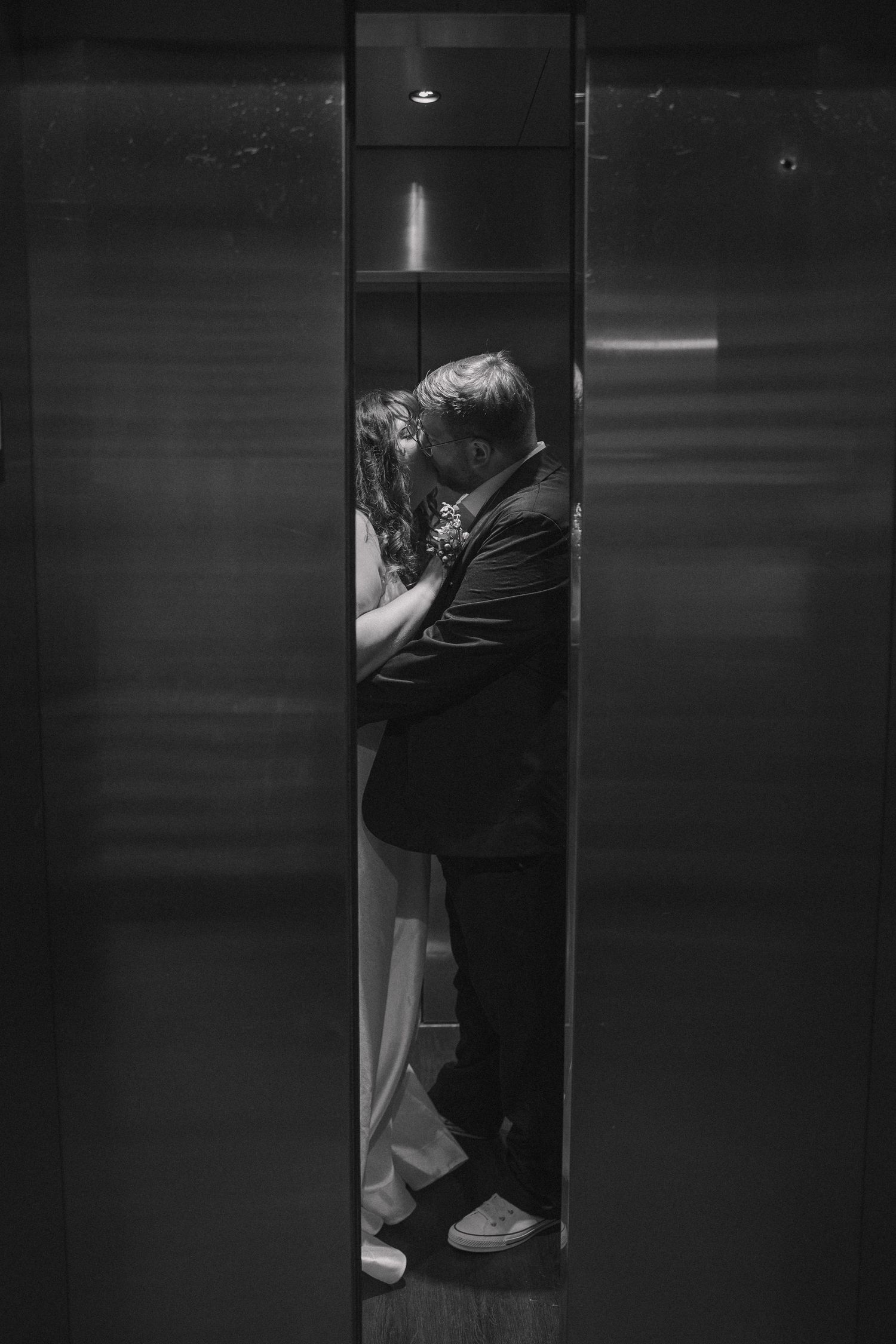 Moody elevator photo of bride and groom on their wedding day at the Graduate Hotel.