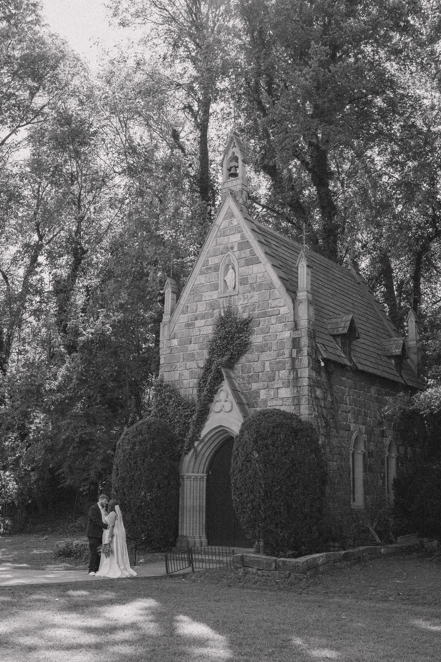 Bride and groom far off in the distance showcasing the full picture of the St. Catherine's at Bell Gable wedding venue in black and white.