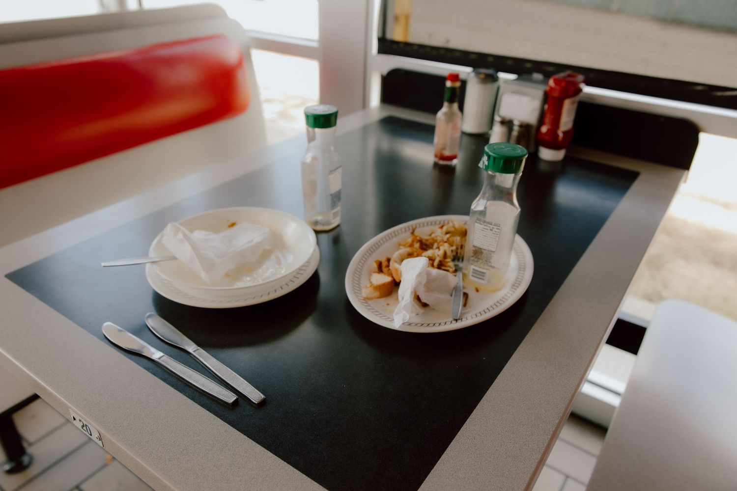 Documentary photojournalism style photo of plates and food left at the Waffle House to tell the story of their elopement wedding day.