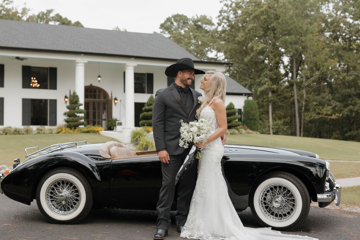 Couple with vintage car in front of Houston's Venue in Brookland, Arkansas. A classic southern style hidden gem wedding venue located in NEA