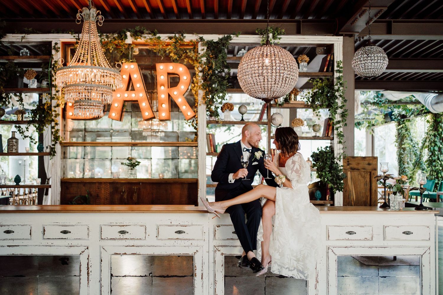Rustic wedding reception venue with exposed wooden beams and elegant white decor details.