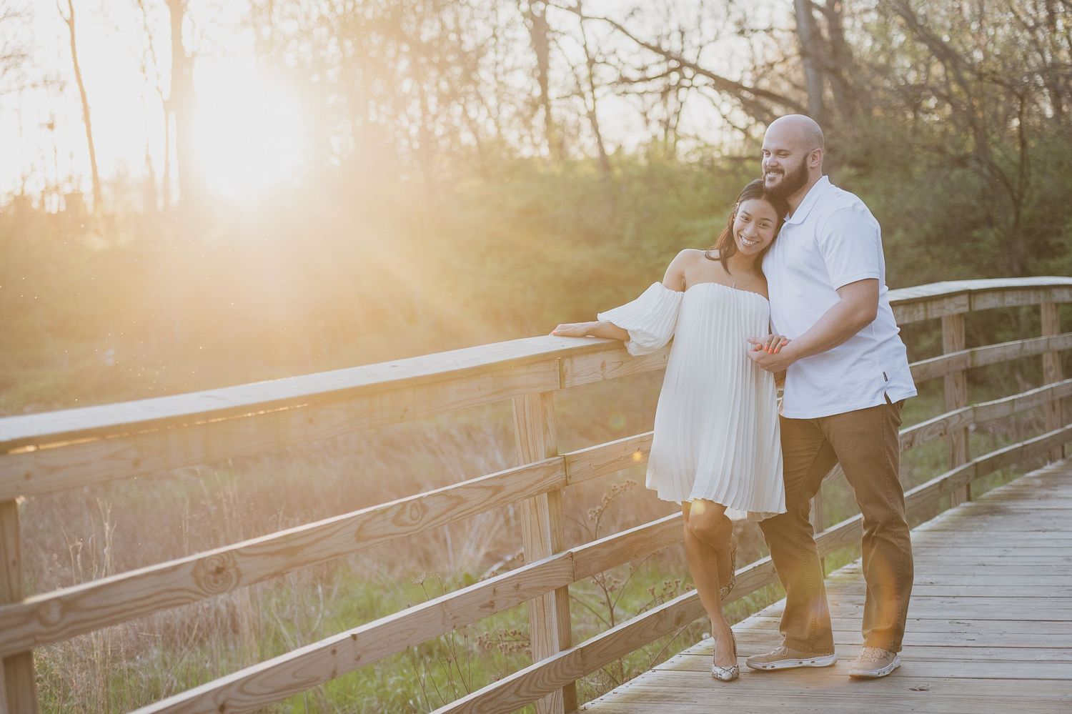 Couple shares intimate moments on wooden bridge during sunset photoshoot. Palm Coast, St. Augustine engagement photographer.