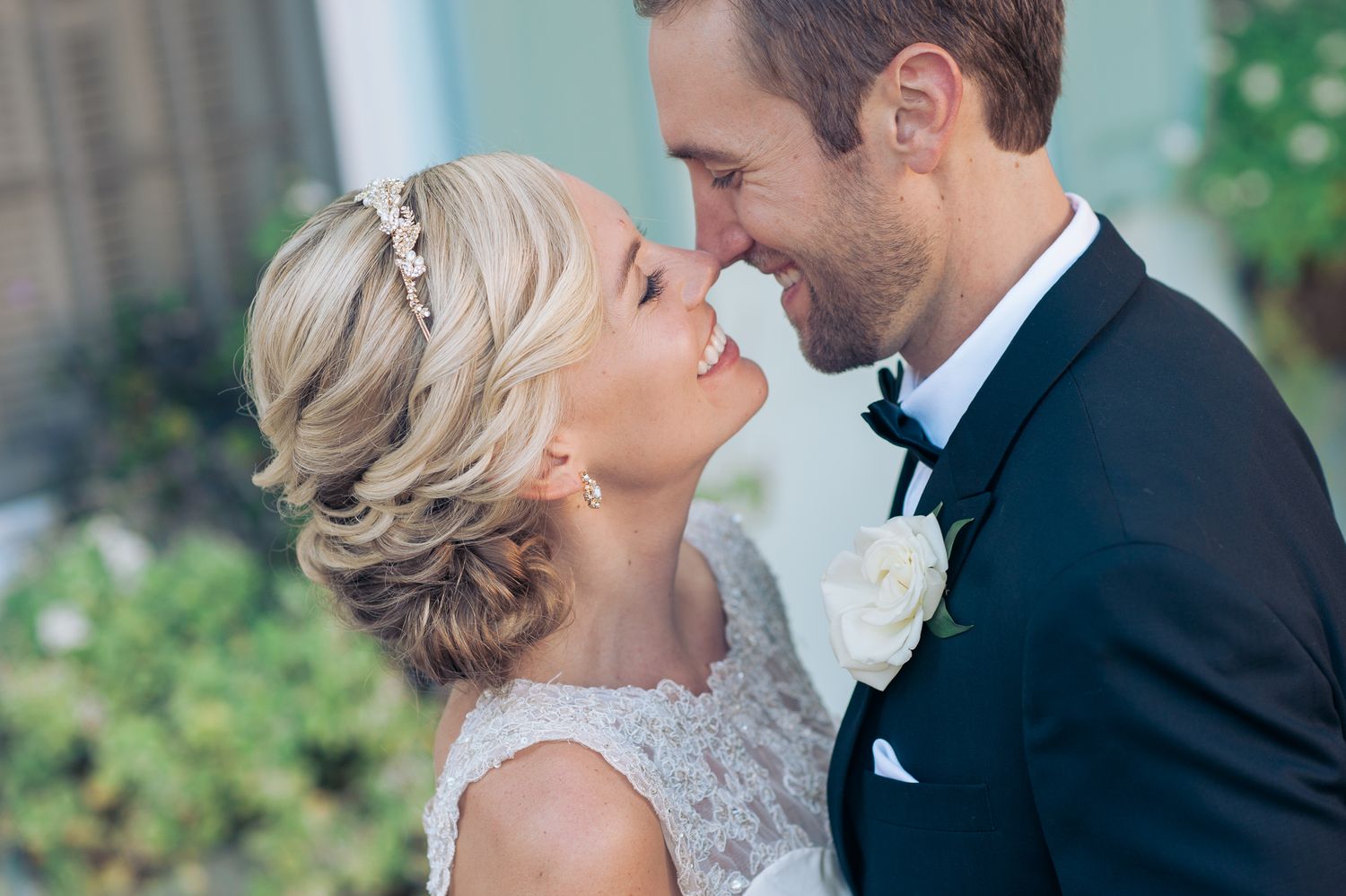 Intimate wedding couple portrait in black and white formal attire.