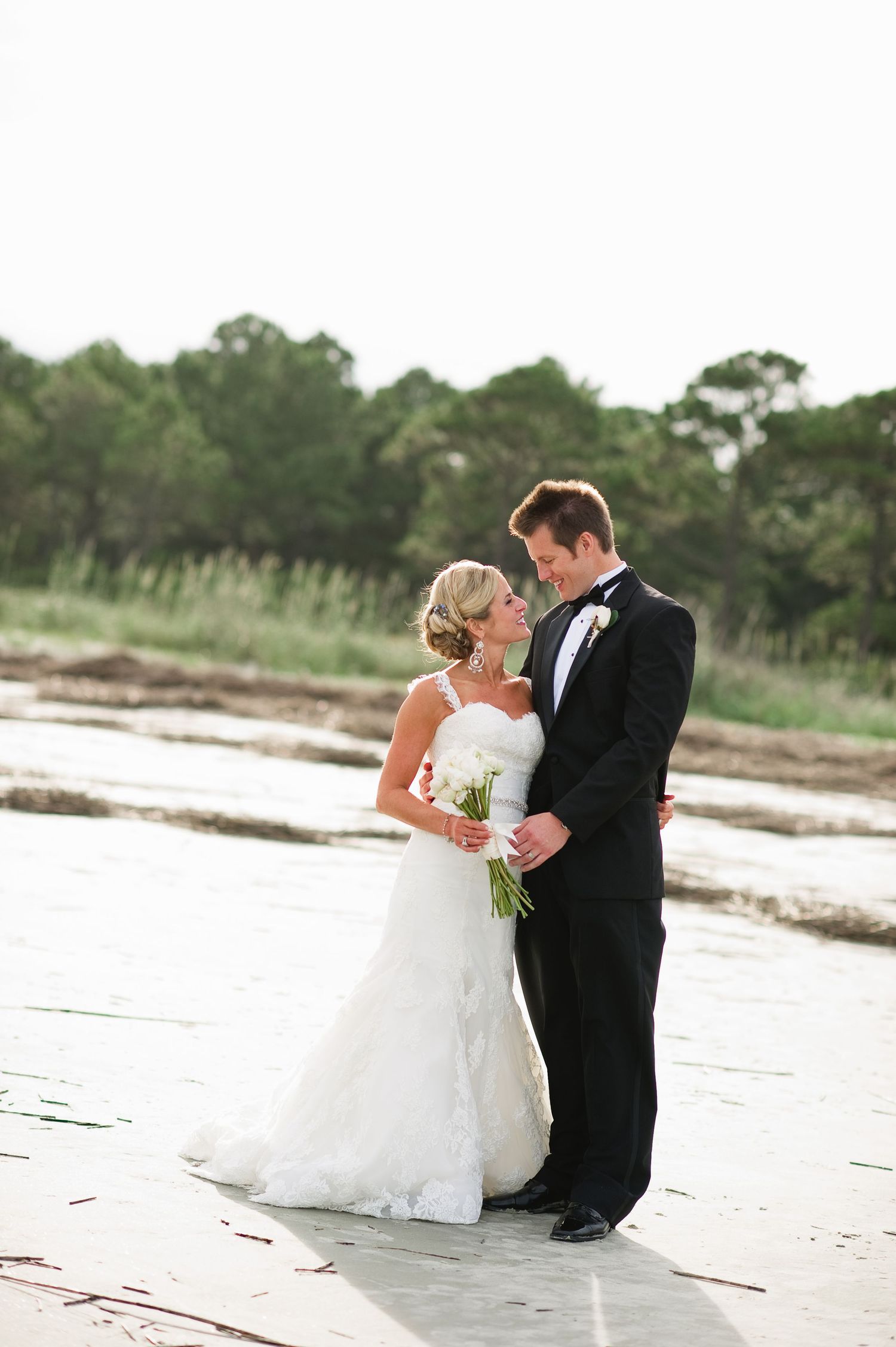 A romantic beach Hilton Head wedding photo sequence shows a couple sharing tender moments on the sandy shore at sunset.