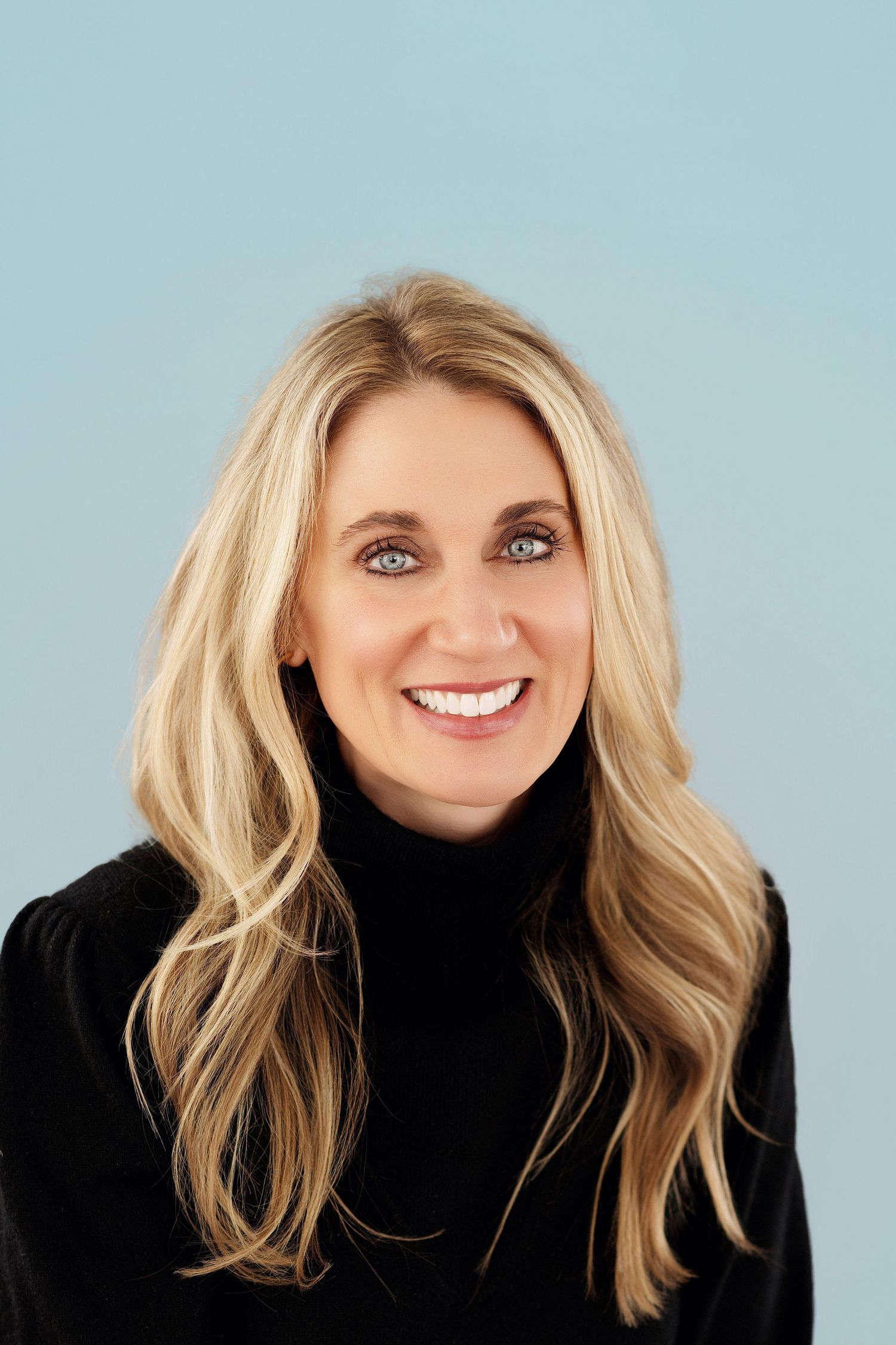 Professional studio headshot series showing blonde hair and black turtleneck sweater against light blue background.