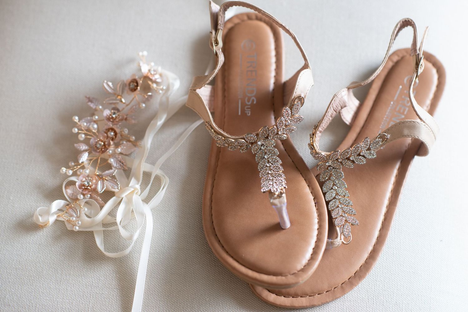 Rose gold bridal sandals with crystal embellishments and delicate straps.