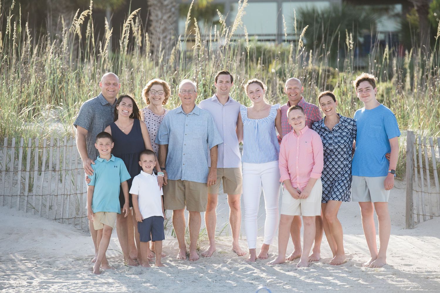 Extended family gathering posed together on a beach path with dune grass in late afternoon light.Hammock Beach, Sea Pines coastal photograph