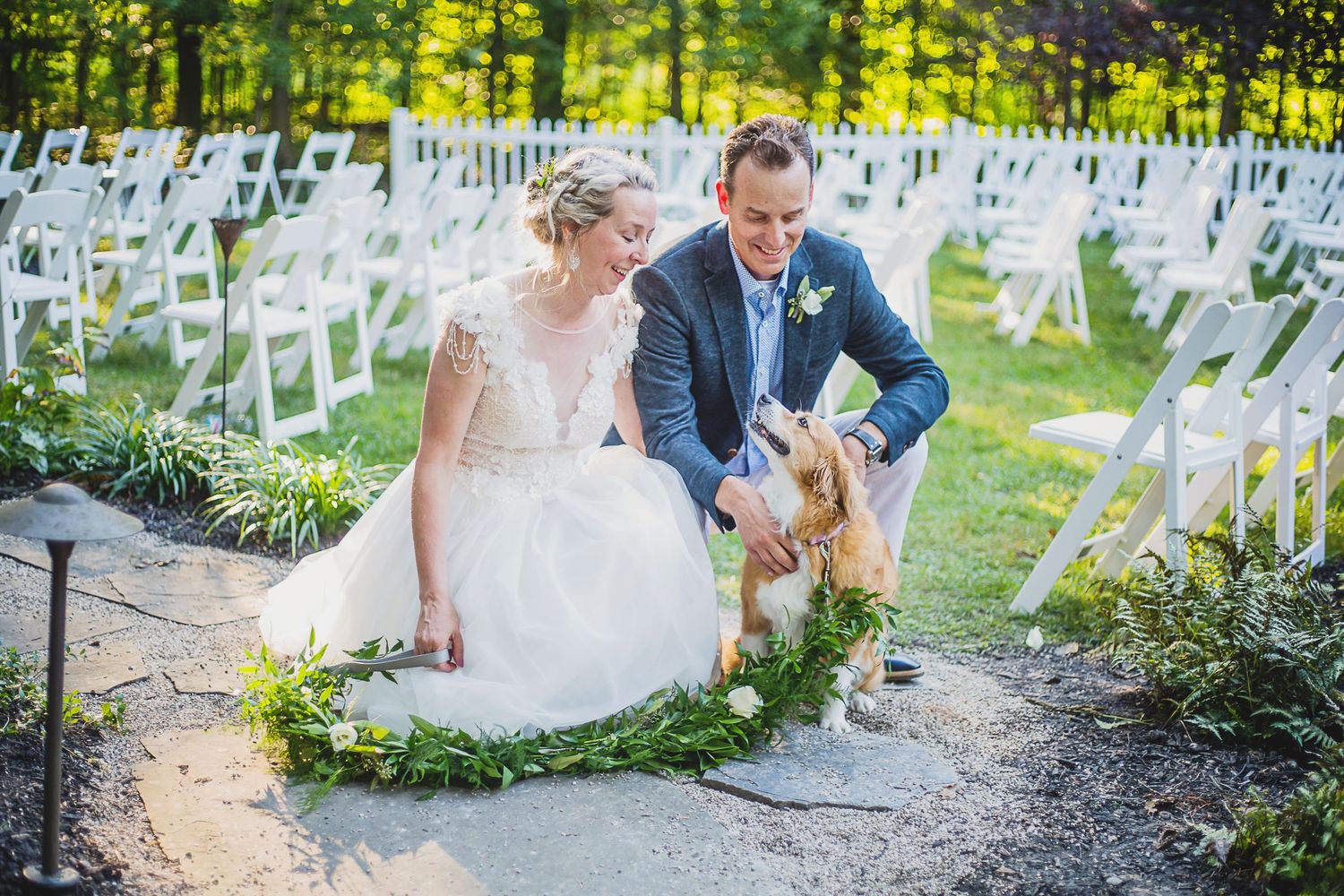 Outdoor wedding ceremony setup with white chairs and natural greenery. Columbus, Ohio backyard wedding.