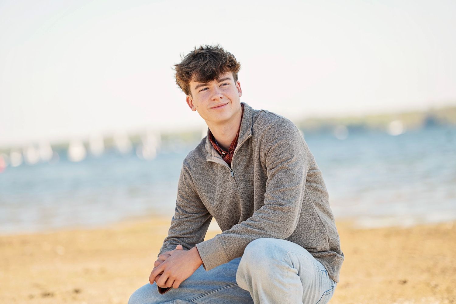 A casual portrait session at the beach featuring someone in a grey sweater.