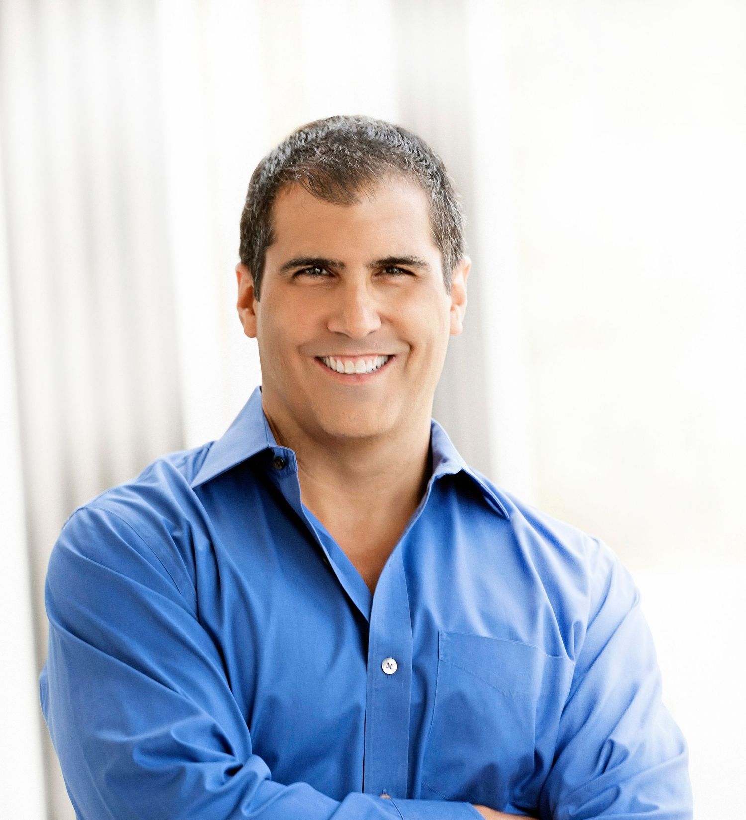 Professional headshot series of person in blue button-down shirt against white background.