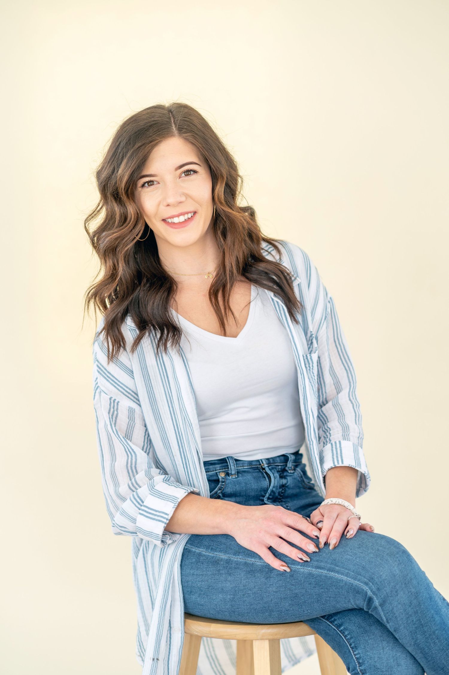 Portrait series showing casual style with striped button down shirt and jeans in natural lighting.